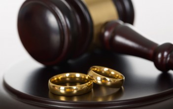 Close-up Of Wedding Rings And Wooden Gavel
